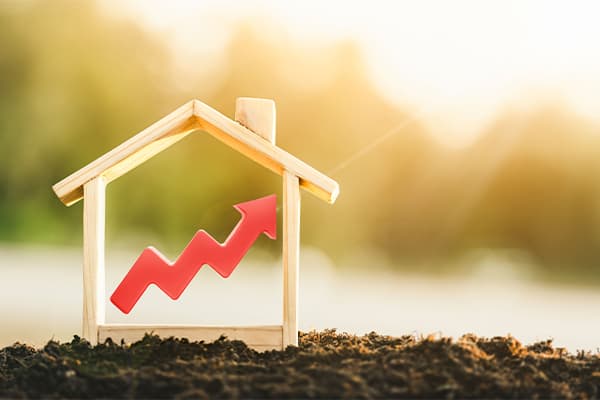 Wooden-model-house-and-red-arrow-up.