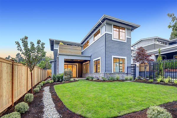 Exterior-of-grey-blue-craftsman-style-home-with-Welcoming-backyard-and-covered-patio.