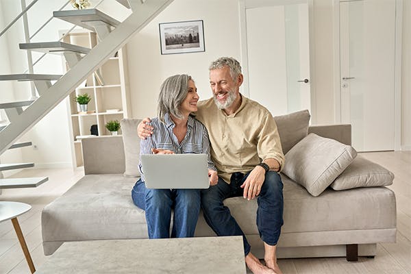 Happy-senior-mature-family-couple-using-laptop-computer-at-home